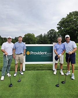 Group photo in front of the Provident Bank GAP sign